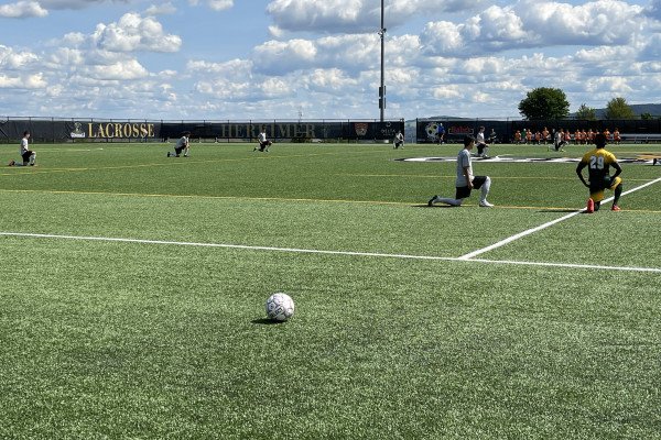 Mens Soccer kneeling 1