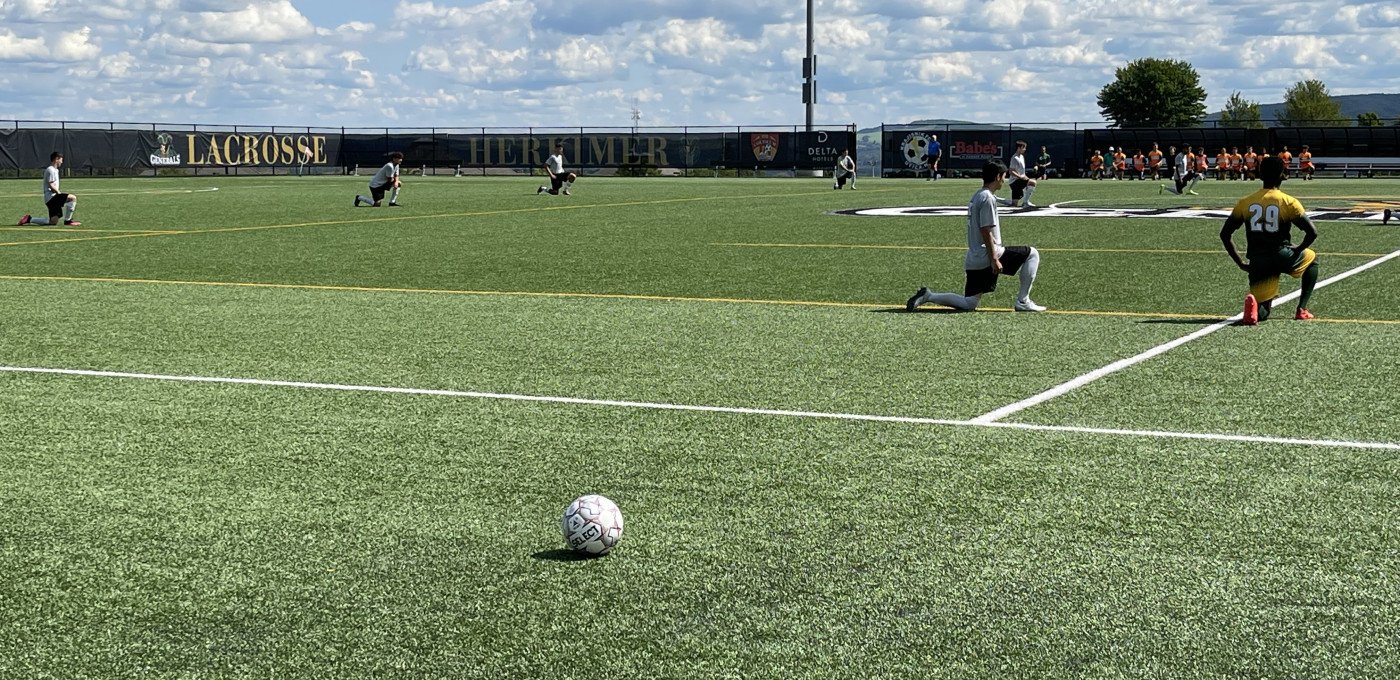 Mens Soccer kneeling 1