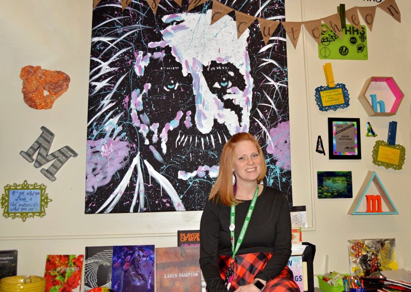 McCutcheon 1 121919 v2 Heather McCutcheon sits in her classroom in front of a wall of artwork.
