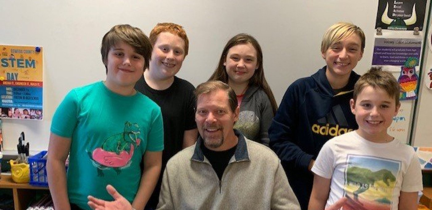 alum john mercer author with students