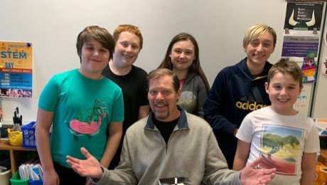 alum john mercer author with students