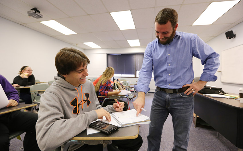 Math Instructor Works With Student